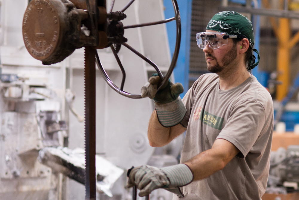 Man working in an industrial workshop wearing eye tracking glasses