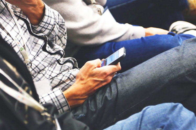 Person reading text on a mobile phone