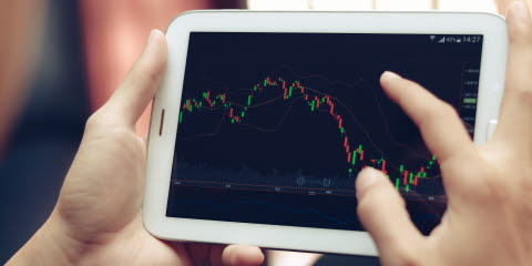 Person looking at the stock market on a tablet