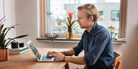 Man looking at a laptop using an eye tracker