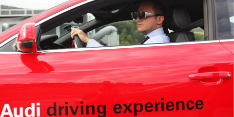 A man driving an Audi car wearing Tobii Pro Glasses.