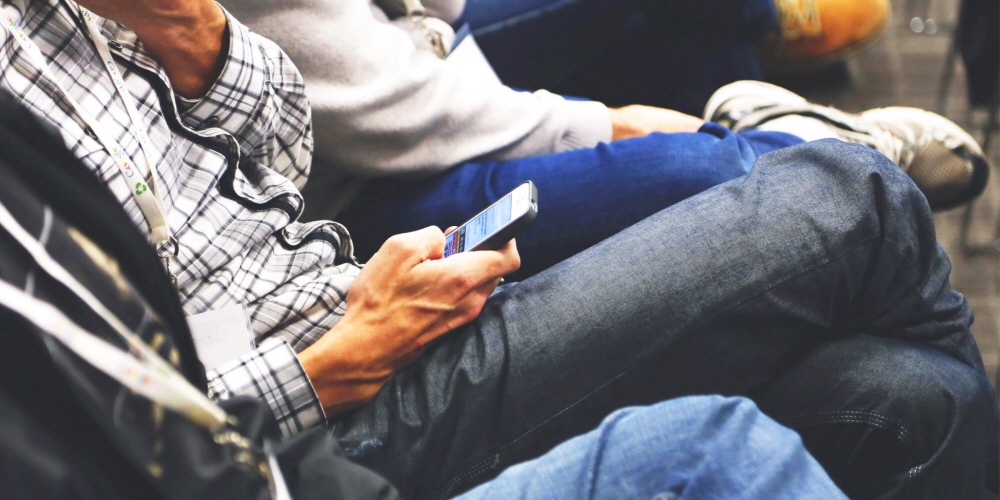 Person reading text on a mobile phone