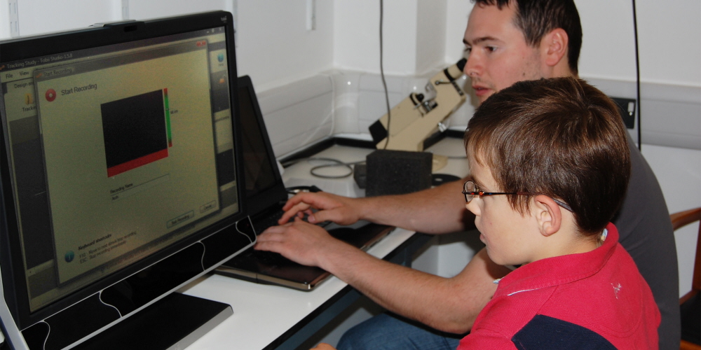 A young participant going through the calibration process on the T60XL eye tracker.
