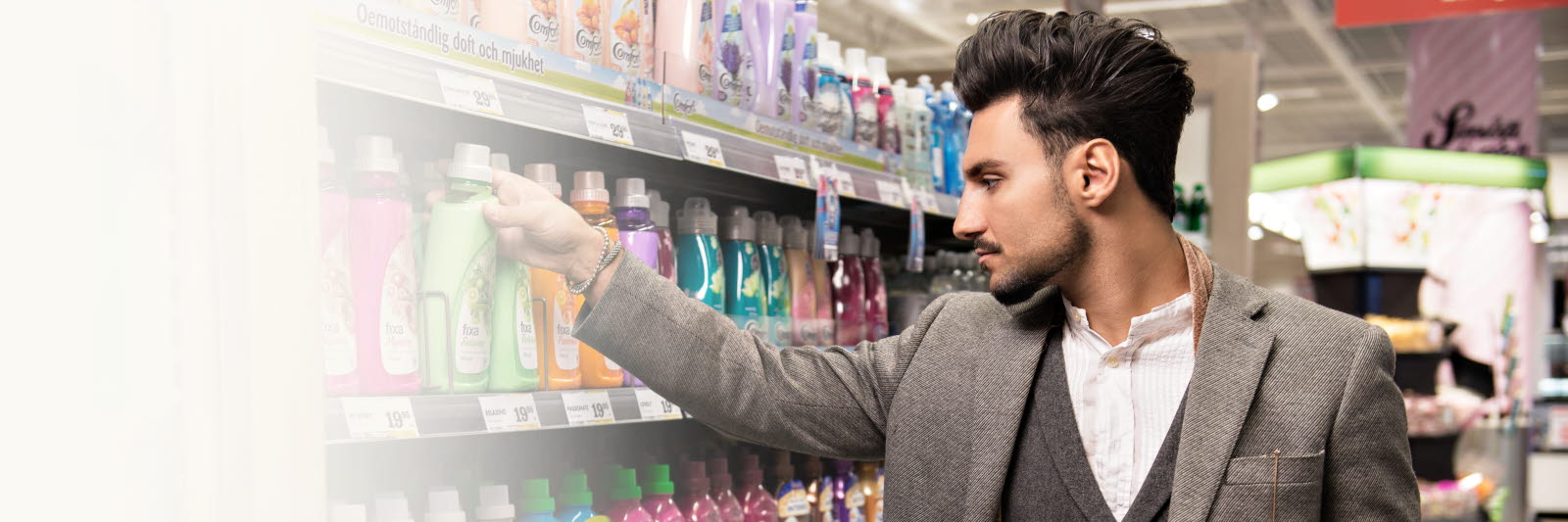 Man reaching for a product on a shelf