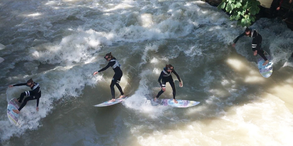Four people perform surf runs while wearing Tobii Pro Glasses 2.