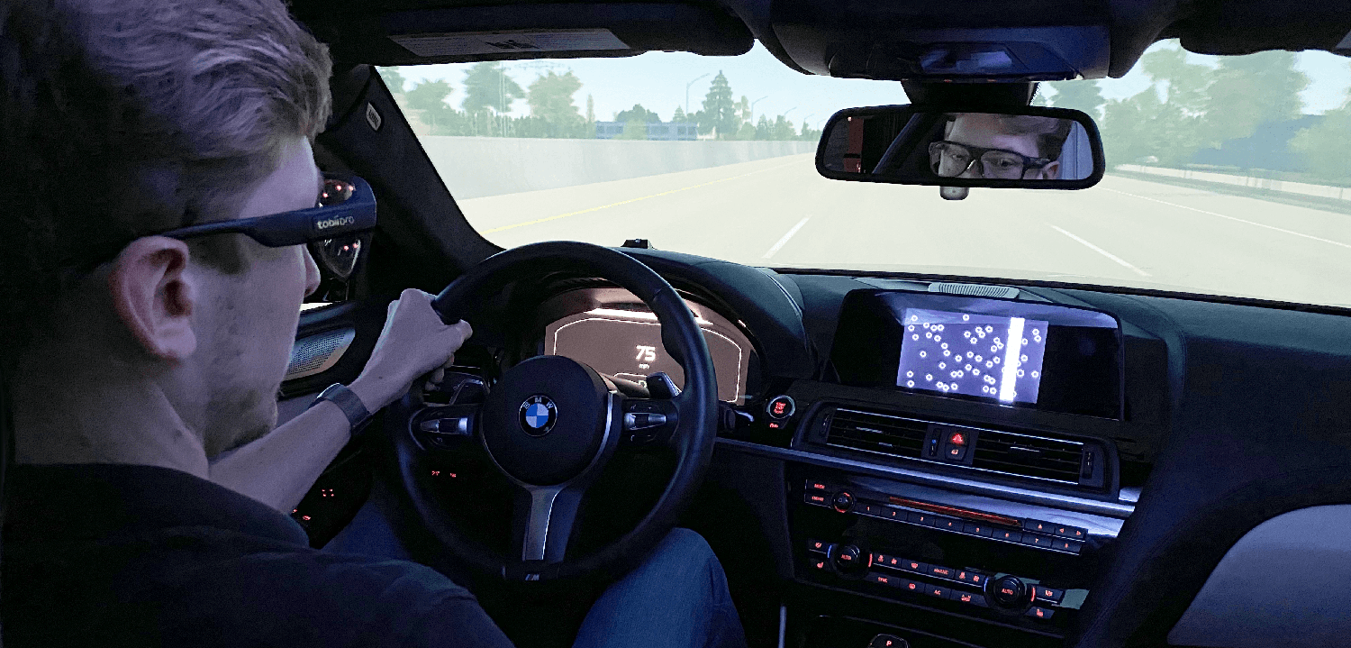 A person driving a car using Tobii Pro Glasses 3